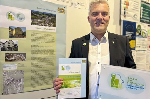 Bürgermeister Timo Ehrhardt zeigt stolz das Gütesiegel, das die Stadt Ludwigsstadt als „Flächenbewusste Kommune“ ausweist. Foto: Stadt Ludwigsstadt