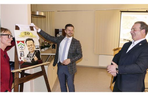 Bürgermeister Dieter Möhring (rechts) freute sich über die Karikatur, die ihm (von links) seine Stellvertreter Ruth Schwappach und Thomas Wagenhäuser zu seinem Amtsjubiläum überreichten. Foto: Christian Licha