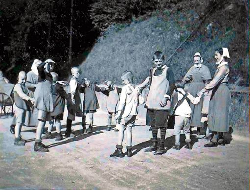 Geistigbehinderte Kinder des Gottlob-Weißer-Hauses in Schwäbisch Hall spielen Rigelreihen mit zwei Schwestern. Die Nationalsozialisten ermordeten gezielt beeinträchtigte Kinder - auch im Landkreis Kronach. Foto: Archiv dpa